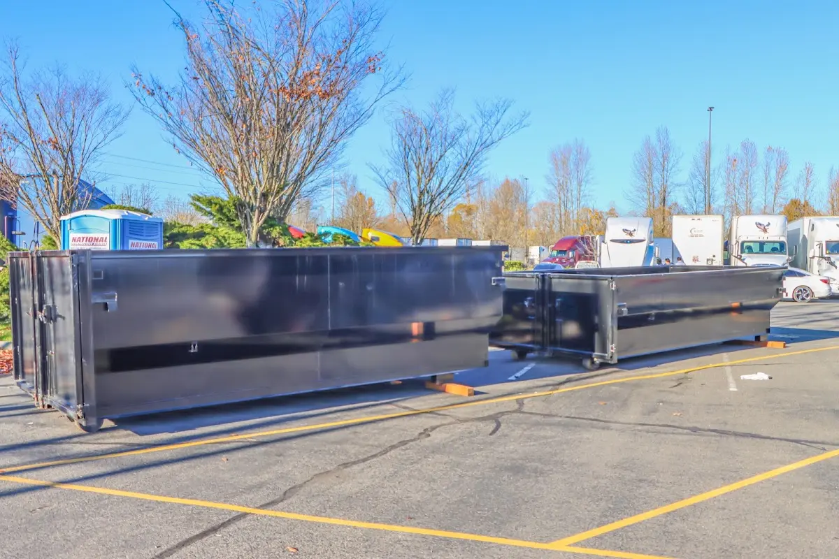 Professional dumpster rental service with roll-off container on residential driveway in Panama City